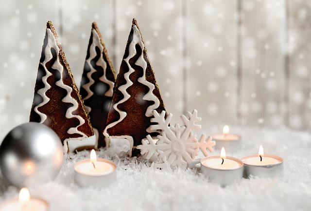 Christmas tree biscuits a snowflake and tea lights a white scene
