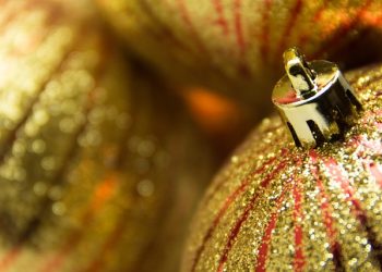 A closeup of gold and red striped glittery ball ornaments