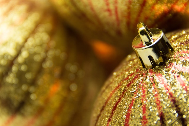 A closeup of gold and red striped glittery ball ornaments